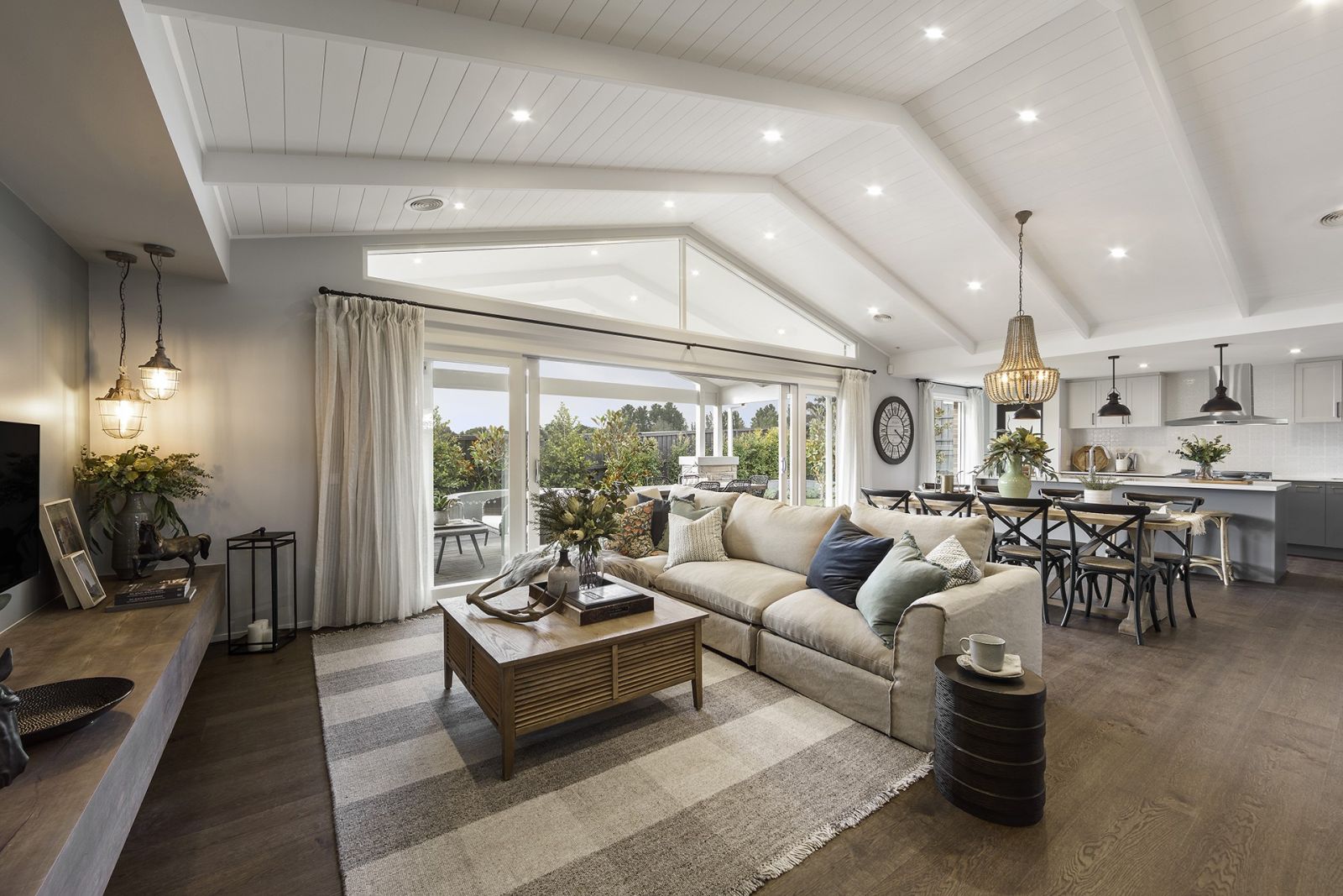 modern country living room and dining room with thonet chairs in black and white clay pendant light